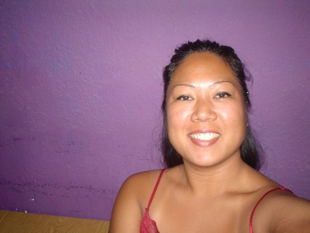 Radiant Smile before the Purple Wall