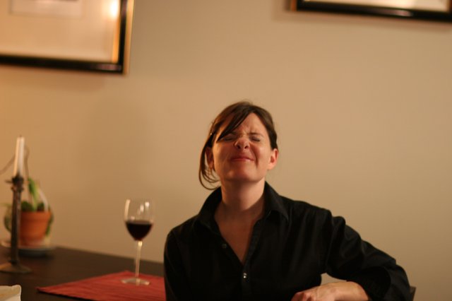 Woman Savoring Red Wine at Restaurant Table