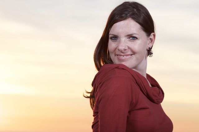Smiling Woman Glances Back at Golden Sunset