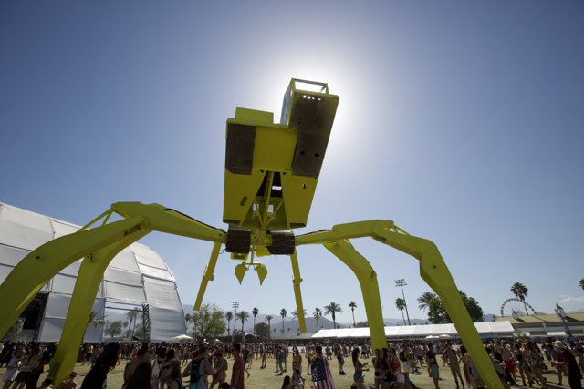 Giant Yellow Spider Sculpture Stands Tall in the Middle of a Crowd