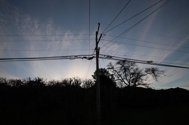 Silhouetted Power Lines Against Twilight Sky