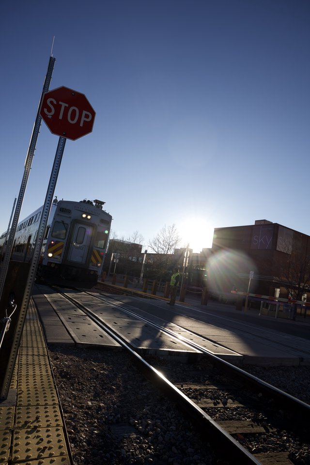 Train Crossing at Dusk with Stop Sign