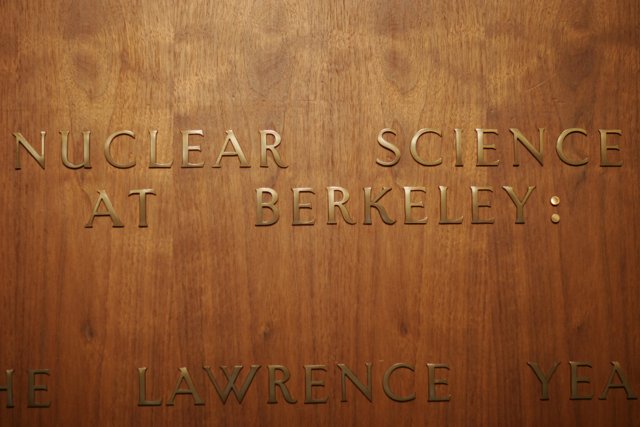 Engraved Nuclear Science Plaque on Stained Wood Door
