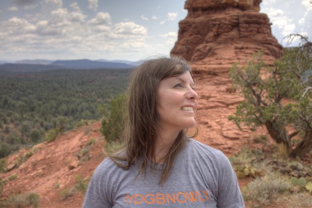 Woman Smiling Amid Sedona's Red Rock Formations