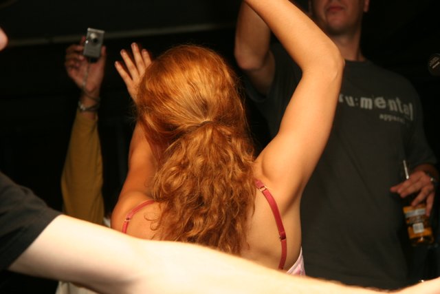 Red-haired Woman Dancing at an Urban Night Club