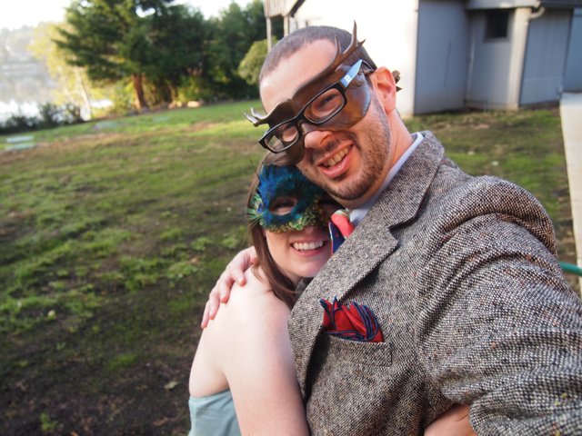 Masked Couple Embracing at Outdoor Masquerade Party