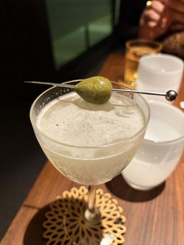 Elegant Martini with Olive Garnish at Upscale Bar