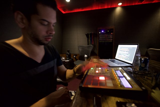Marc Kinchen working on music with his laptop in the studio