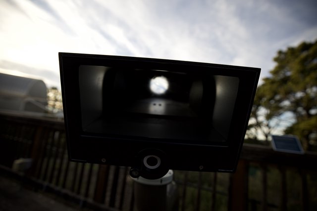 Silhouetted Vintage Camera Against Cloudy Sky