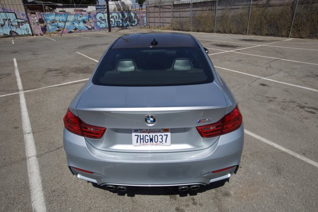 Silver BMW M4 Rear End in Parking Lot