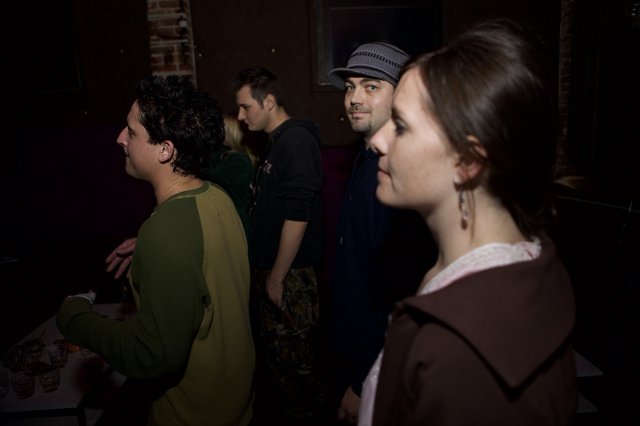 Candid Moments at a Dimly Lit Indoor Gathering