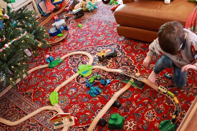 Child Playing with Wooden Train Set on Christmas