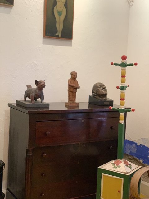 Wooden Chest and Statue on Dresser
