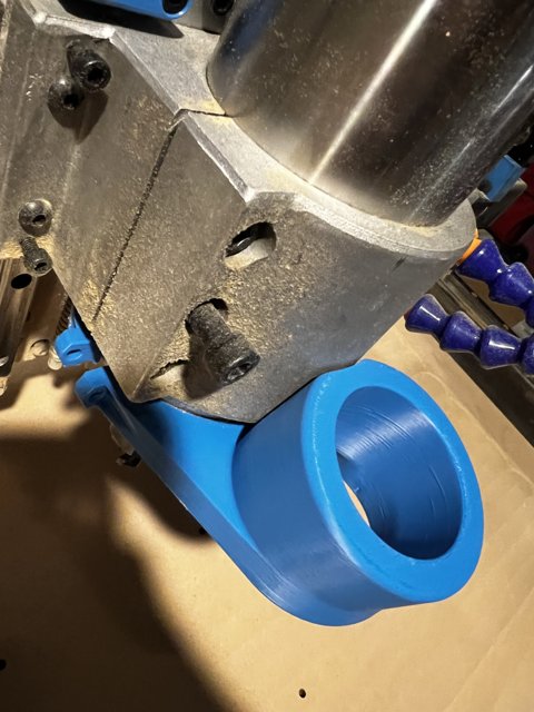 Metal Bracket Clamped to Blue Pipe