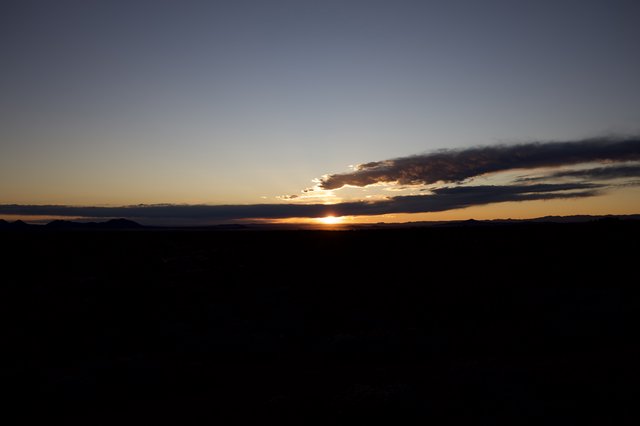 Dramatic Sunset Over Desert Mountains and Plains