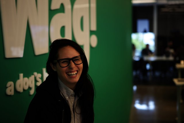 Woman Smiling with WAG Logo in the Background