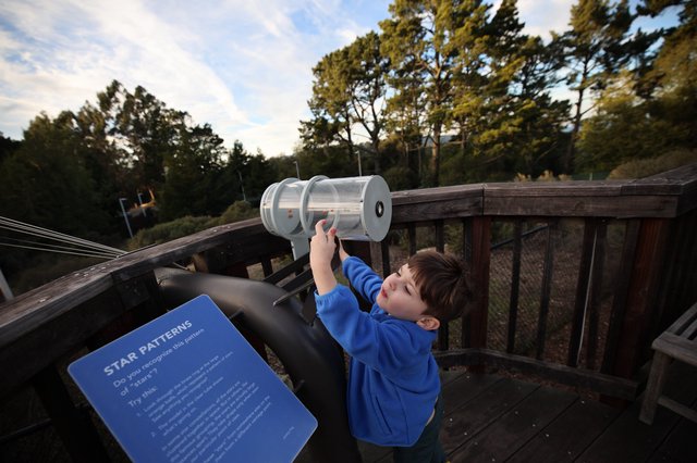 Young Explorer Using Star Pattern Viewer at Observatory Deck
