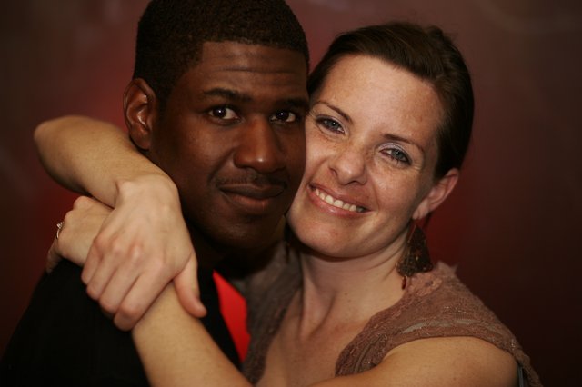 Warm Embrace: Couple Poses Together at Evening Event