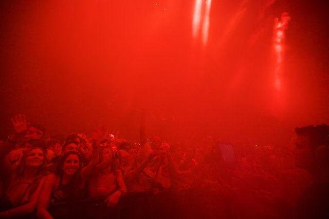 Red Spotlight on a Vibrant Concert Crowd
