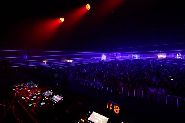Massive EDM Crowd Bathed in Purple Laser Light