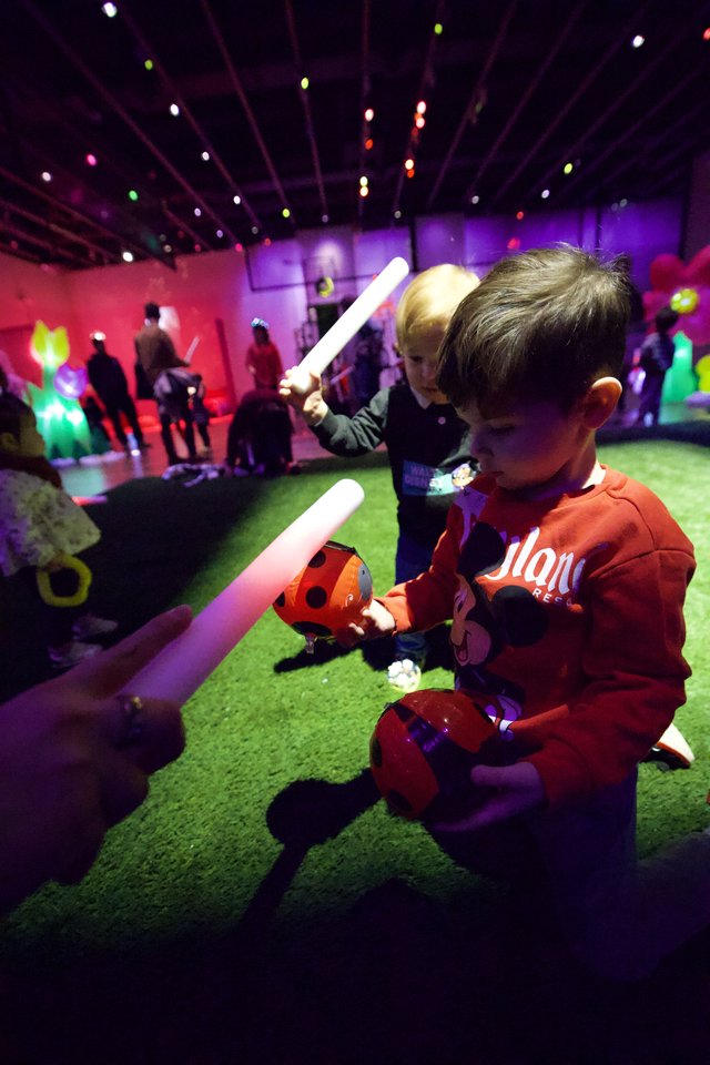 Children Playing with Glow Sticks at Baby Rave Event