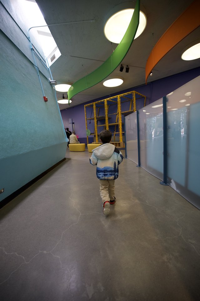 Child Exploring Colorful Modern Play Space Corridor