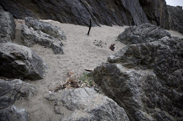 Rocky Cove Beach with Remnants of Campfire