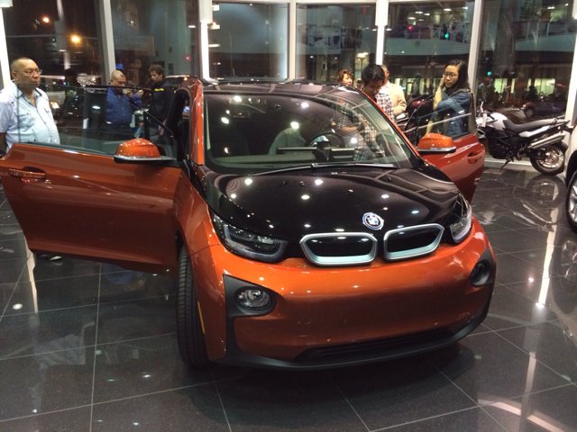 Orange BMW i3 Shines in Car Showroom