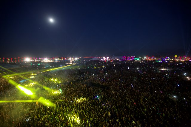Illuminated Concert Crowd under Full Moon