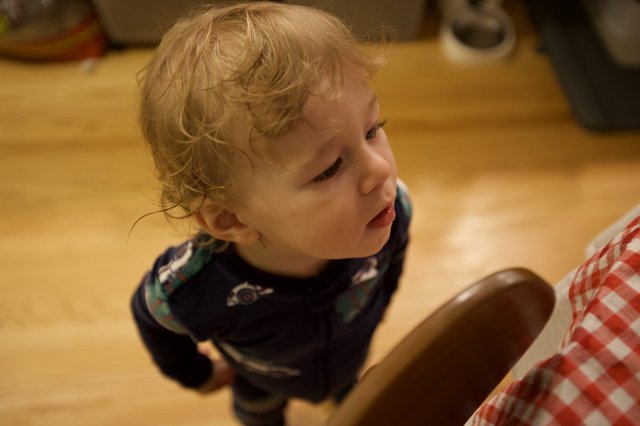 Toddler with Curly Blonde Hair at Christmas Gathering