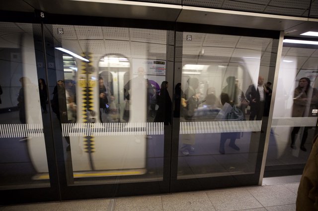 Crowded Underground Platform Through Platform Screen Doors