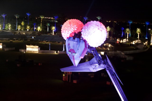 Lighted Balloon Shines Above Cityscape