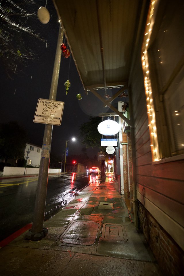 Rainy Night Street Scene with String Lights