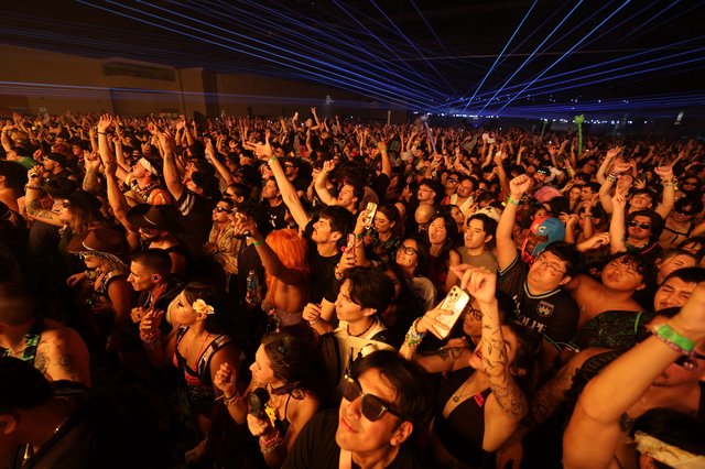 Massive Crowd Erupts Under Blue Laser Light Show