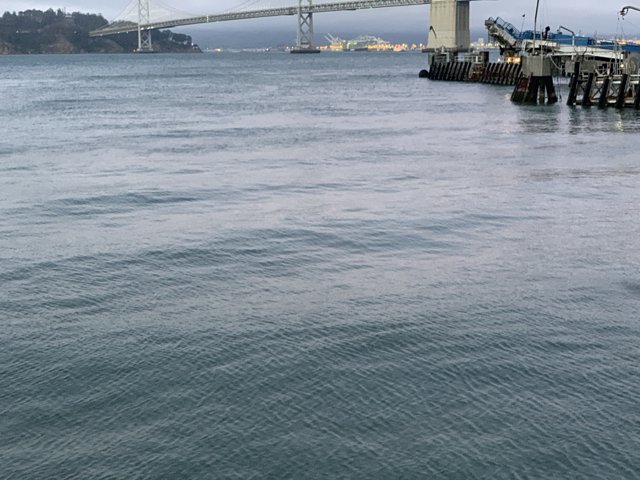 Boat sailing under the bridge