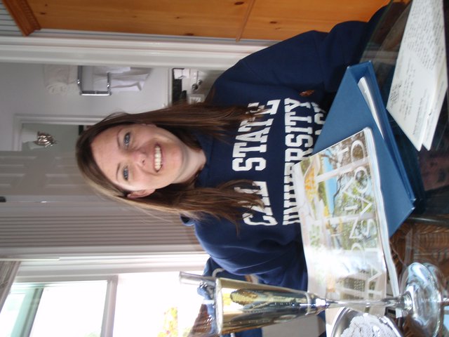 College Student Smiling with Cal State University Sweatshirt
