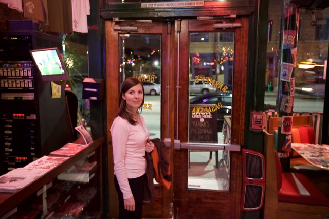 Woman at Entrance of Barney's Restaurant at Night