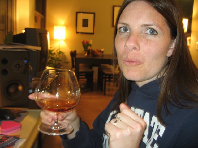 Woman Enjoying Brandy in Cozy Living Room