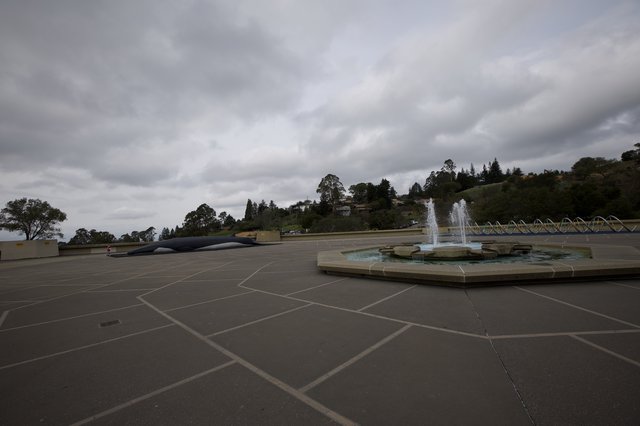 Cloudy Plaza with Fountain and Modernist Sculpture