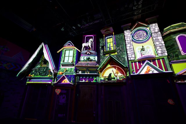 Whimsical Neon-Lit Miniature Village Display at Night
