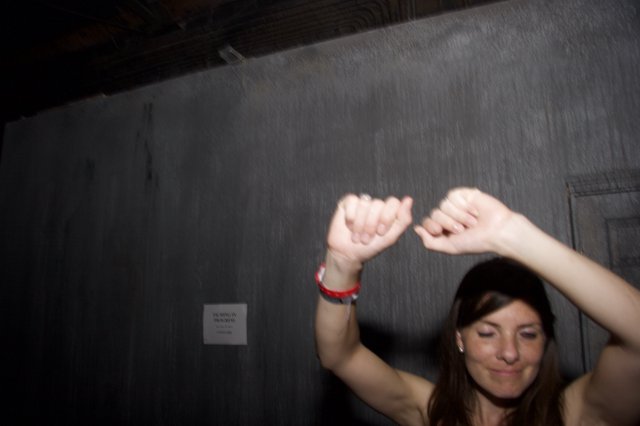 Woman Dancing with Arms Raised at Night Event