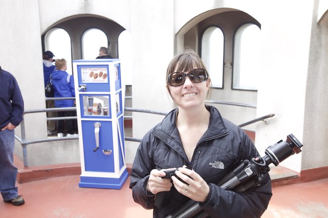 Photographer Smiling at Pressed Penny Souvenir Machine