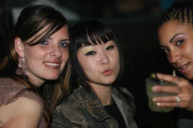 Three Friends Posing at a Nightclub Party Night
