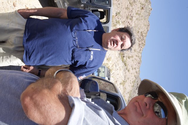 Two Men Conversing in Arid Desert Terrain