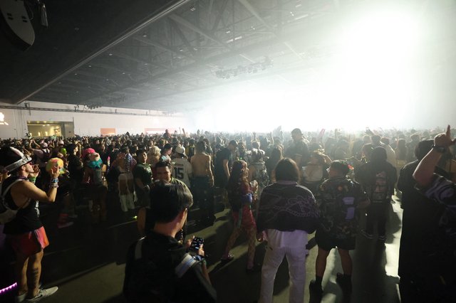 Massive Indoor Rave Crowd Erupts Under Blinding Stage Lights