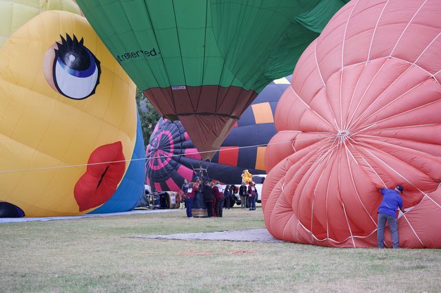 Ground Crew Prepares Colorful Balloons at Classic Festival
