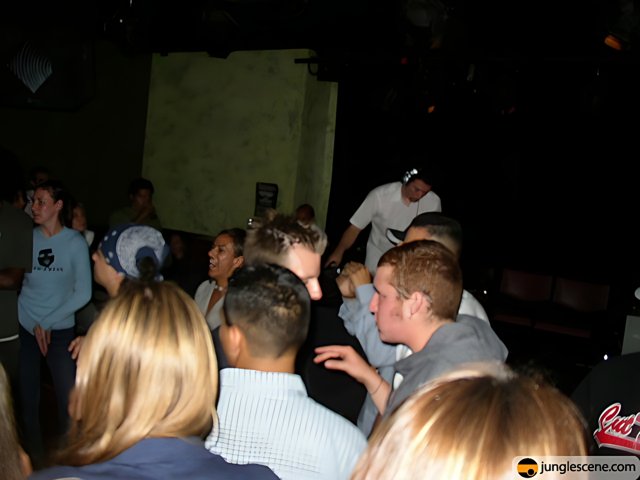 Crowd gathers around man at nightclub