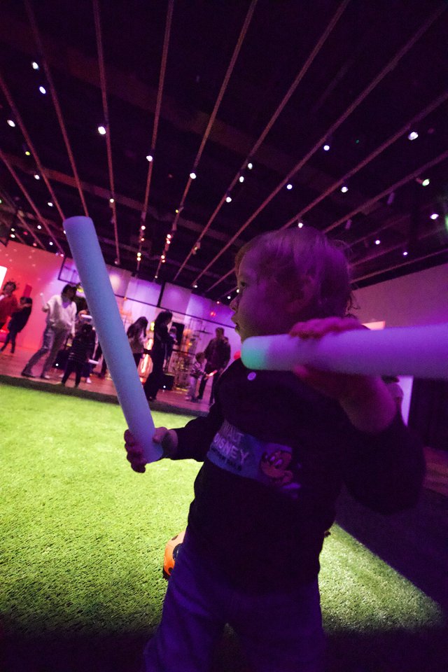 Child with Light Saber at Baby Rave Event
