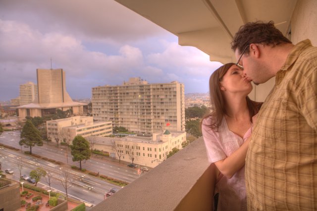 Romantic Balcony Kiss Over San Francisco Cityscape