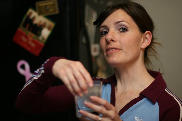Woman Holding a Glass in Casual Home Setting